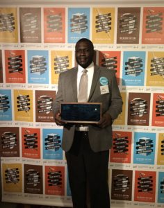 Image is of Willie Brake, Owner of All About Technology which is a Detroit based Minority and Disabled-Owned Business. Willie is proudly holding his award for business growth ideas.