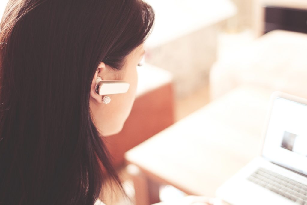 Woman wearing an earpiece.