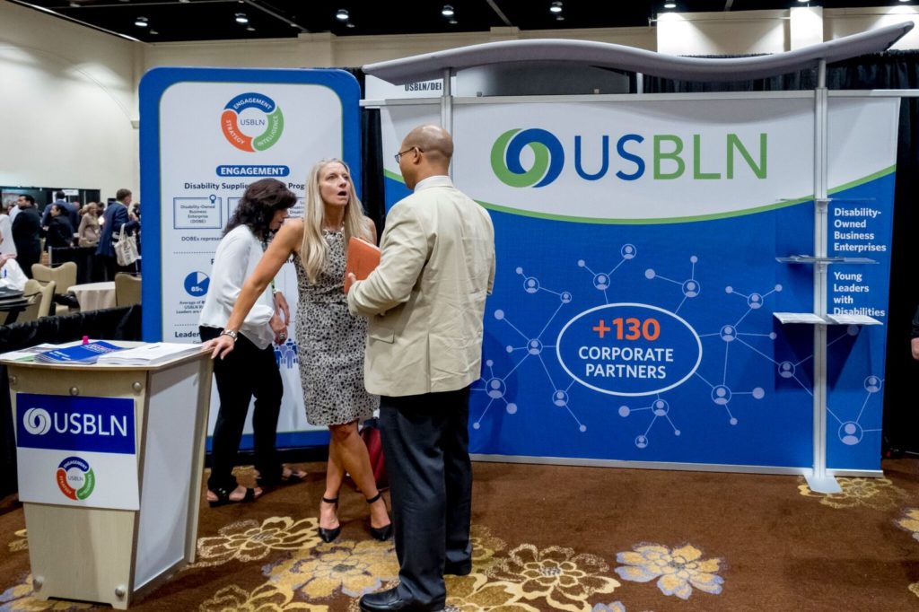 USBLN consultant Beth Butler chats with conference attendees about Going for the Gold.