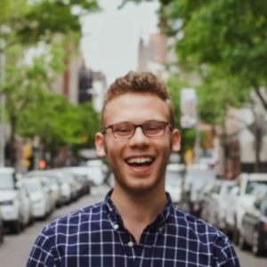 Photo of Bryan Stromer standing in a city street and smiling